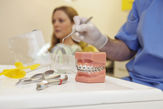 orthodontist with adolescent patient